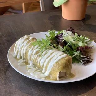 Juicy tempeh &quot;chicken&quot;, grilled onions, Spanish rice, black beans, and  pico de gallo wrapped in a warm flour tortilla then bathed in salsa