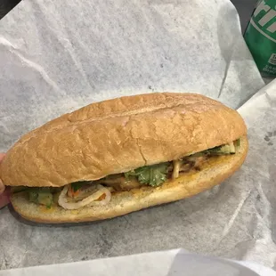 a hand holding a sandwich