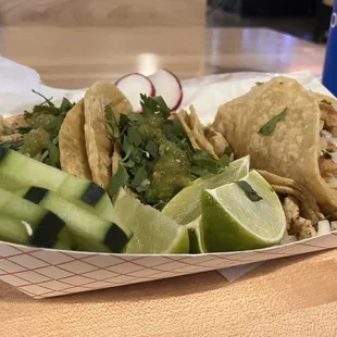 a basket of tacos and cucumbers