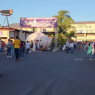 a crowd of people standing in a parking lot