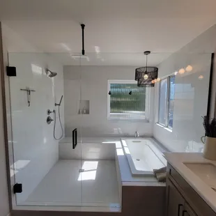 Beautiful remodeled bathroom with a custom oversize frameless shower door