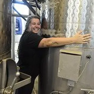 a woman standing next to a tank