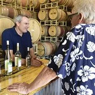 a man and a woman in a wine cellar