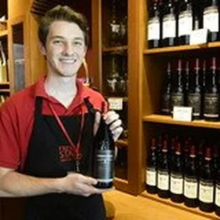 a man holding a bottle of wine