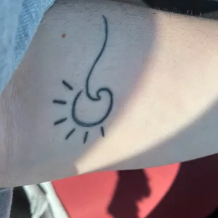 Sun and wave tattoo