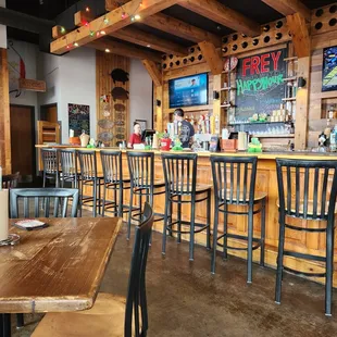 a bar with wooden tables and chairs