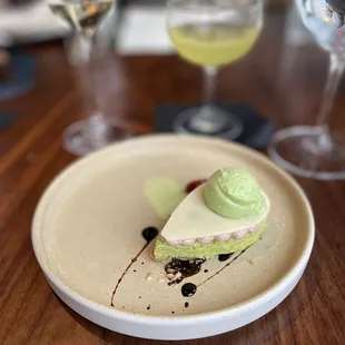 a plate with a piece of cake and a glass of wine