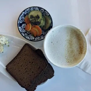 a plate of bread, a cup of coffee, and a bowl of salad