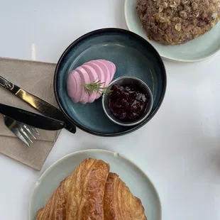 Croissant with lingonberry jam, pickled egg, raspberry oat scone