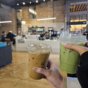 a person holding a cup of iced coffee