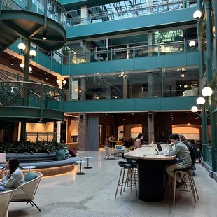 people sitting at tables in the atrium