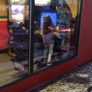 the reflection of a person in a store window