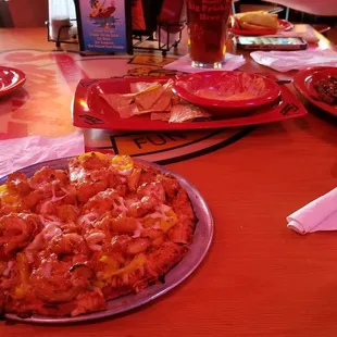 Fricken chicken pizza, fricken chicken dip and chips, and a steak sandwich