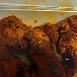 chicken wings and rice in a styrofoam container