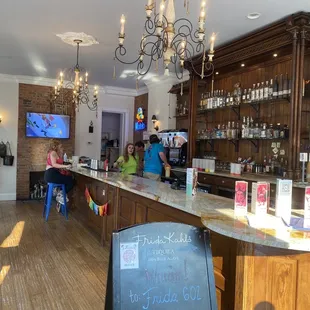 a bar with a chalkboard sign in front of it