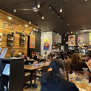 people sitting at tables in a restaurant