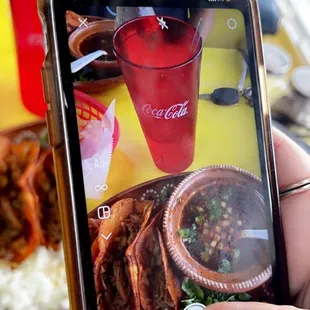 a person taking a picture of a meal on a smartphone