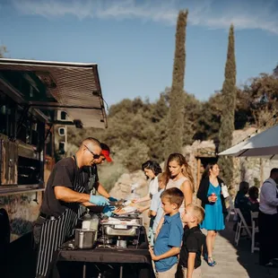 a man serving food to a group of people