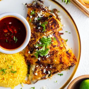 Birria quesadilla with saffron rice and consome dipping sauce!