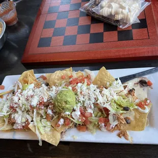 Orale Nachos
 
 Tortilla chips loaded with tinga chicken , queso, guacamole, black beans, pico de gallo, sour cream and shredded lettuce