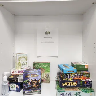 a shelf of books and games