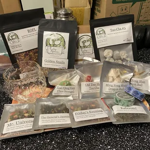 Showing off a haul of tea and things I bought. There is a sharing cup for gongfu cha, a few 1oz bags and a variety of sample sized bags.