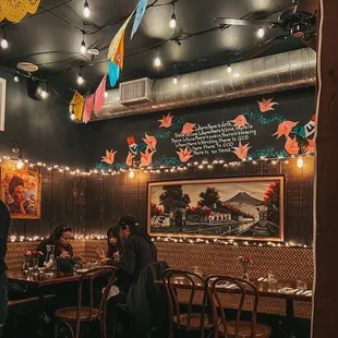 people sitting at tables in a mexican restaurant