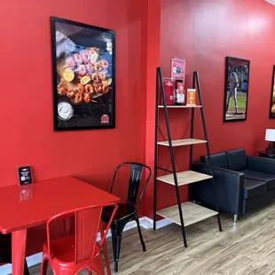 a red dining room with black chairs