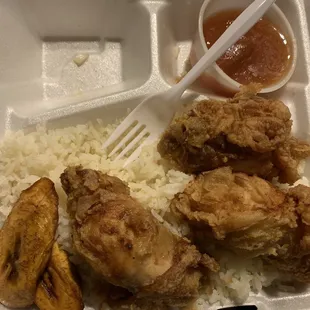a fork and rice in a styrofoam container
