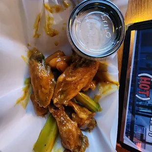 a plate of chicken wings and pickles