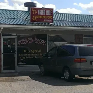 a car parked in front of a restaurant