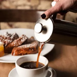 coffee being poured into a cup
