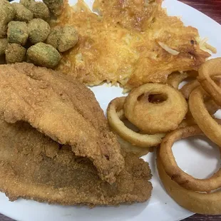 Fried catfish dinner with hash brown casserole, fried okra and onion rings.