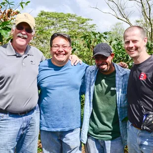 John, far right, has partnered to buy Honduran coffee directly from farmer Jorge Serrano (middle left in blue shirt) since 2012.
