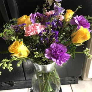 Yellow and purple arrangement. Starts at $30.00