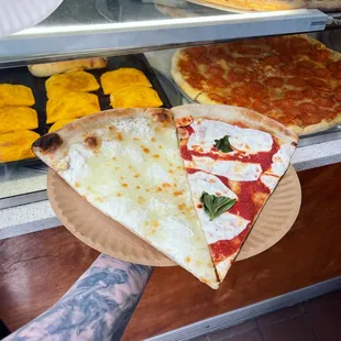 two slices of pizza on a paper plate