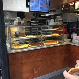 a man eating a slice of pizza