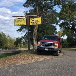 a truck parked in front of a sign
