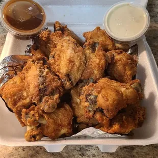 Famous Wings has around 20-25 wings in an order and runs $21. Served with w types of sauces.