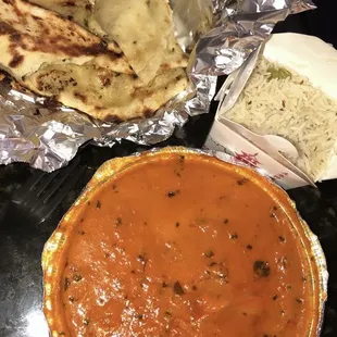 2 orders of garlic Naan, 1 order of medium Butter Chicken with side of rice.