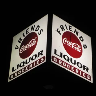 two lighted signs in the dark