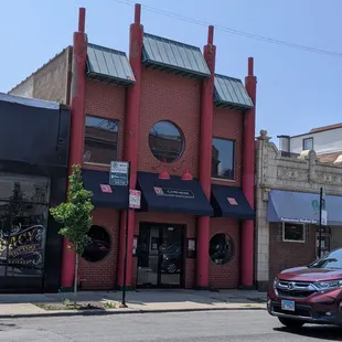 a red building with a black awning