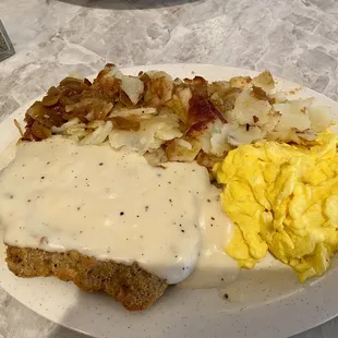 Country fried steak, German potatoes and scrambled eggs.