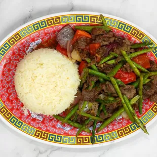 a plate of food with rice and meat