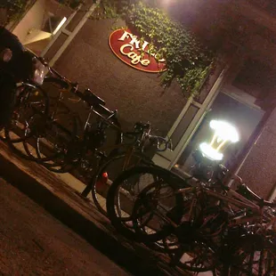 a row of bikes parked in front of a restaurant