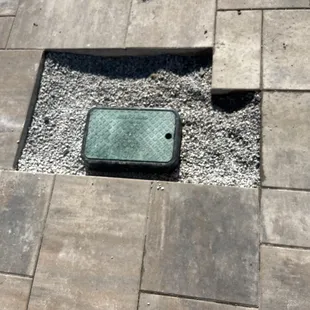 Buried sprinkler wires. Had to tear out and recut. New sprinkler system access.