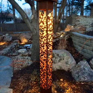 a lamp post in a garden