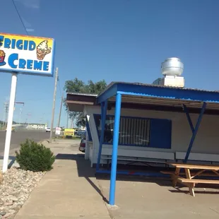 Outside the restaurant. The ordering window is there nearest the sign.