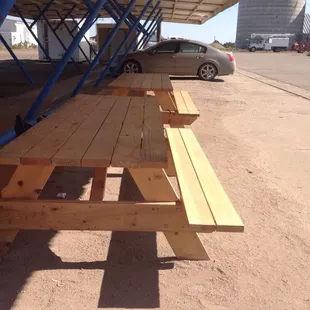 Picnic tables to sit at while you wait for the food, or on which to eat.