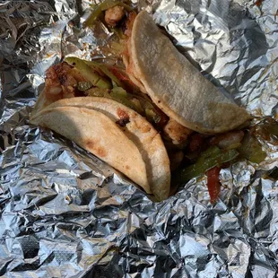 two tacos on tin foil